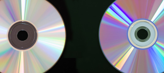 CD and DVD disc on black background