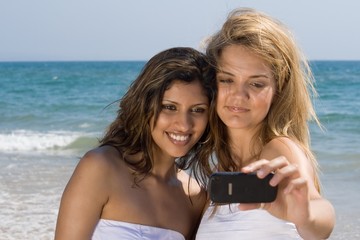 two best friends taking photo on beach