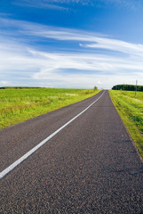 Empty rural road and cloudy sky