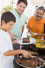 Family Enjoying A Barbeque