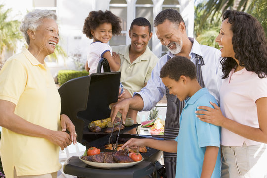 Family Enjoying A Barbeque