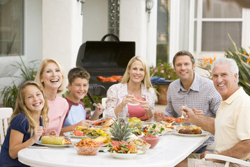 Family Enjoying A Barbeque