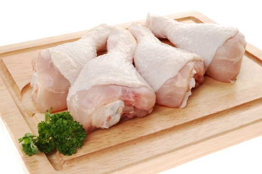 Raw chicken legs isolated on white background