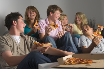 Teenagers Having Fun And Eating Pizza