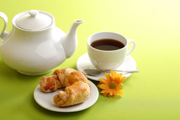 Breakfast concept with coffee and croissant