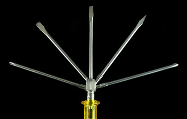 Yellow screwdriver with set of exchangeable nozzles