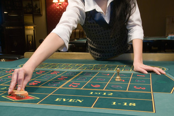 casino dealer handling gambling chips