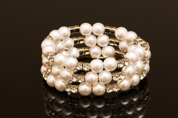 Hand bracelet on the highly reflective background