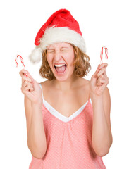 Girl in a santa clause cap with  red and white candy canes