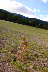 peasant in a field with shovel, mannequin