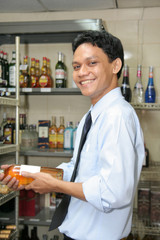 store keeper holding rose wine