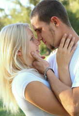 Romantic Caucasian Couple Embracing In Park