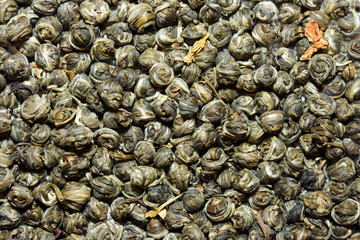 Aromatic green tea leaves close up background