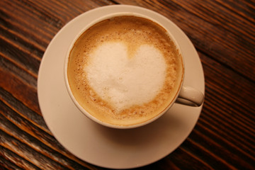 Coffee cup with milk and heart shape