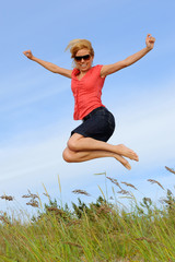 Young blond female jumping