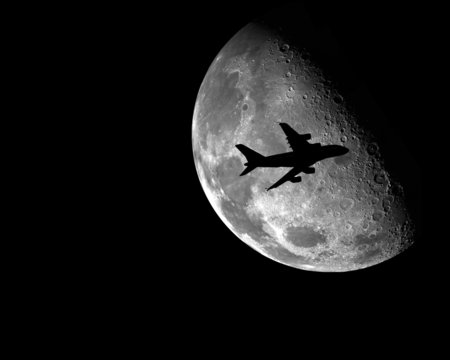 airplane in front of the moon