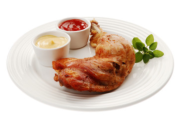 Roasted chicken leg with vegetables isolated on white