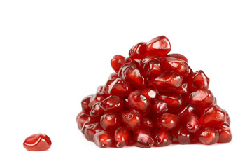 Heap of pomegranate seeds and one seed