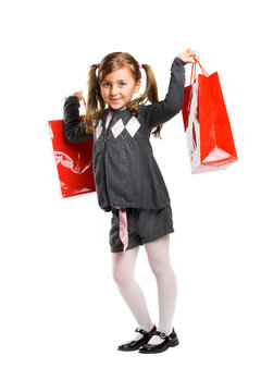 smiling school girl isolated on white with shopping bags