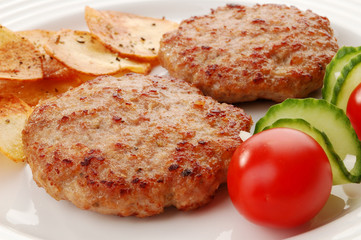 Fried steaks with chips and vegetable salad isolated on white