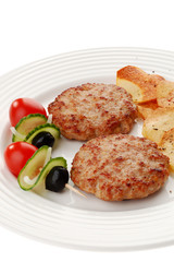 Fried steaks with chips and vegetable salad isolated on white
