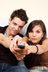 couple sitting on couch watching TV