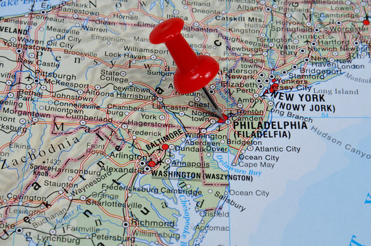 Red pin pointing on Philadelphia on USA map in atlas