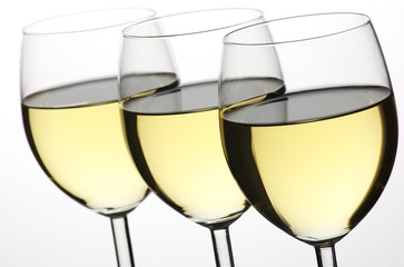 Three glasses of white wine in a row