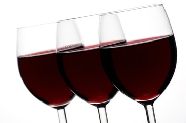 Three glasses of red wine in a row