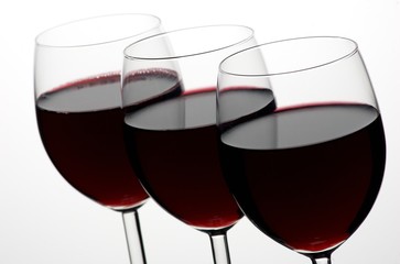 Three glasses of red wine in a row