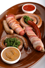 Sausages in assortment with a tomato sauce and mustard.