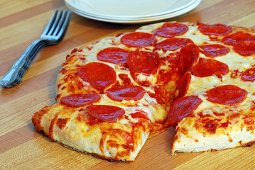 Pepperoni pizza with slice