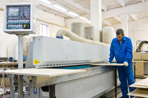 "operating working with wood paneling machine" stock photo a.