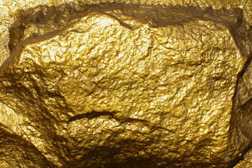 close-up of a golden textured stone with sunny glare