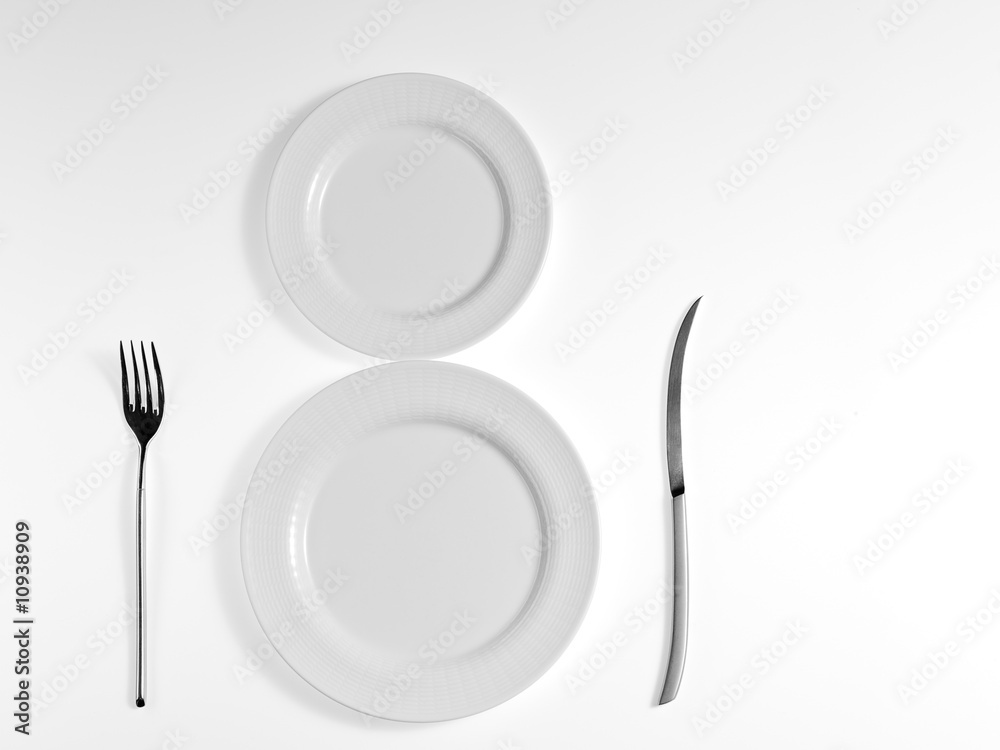 Wall mural white plate on white background with knife and fork.