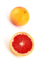 Two fresh grapefruit; white background