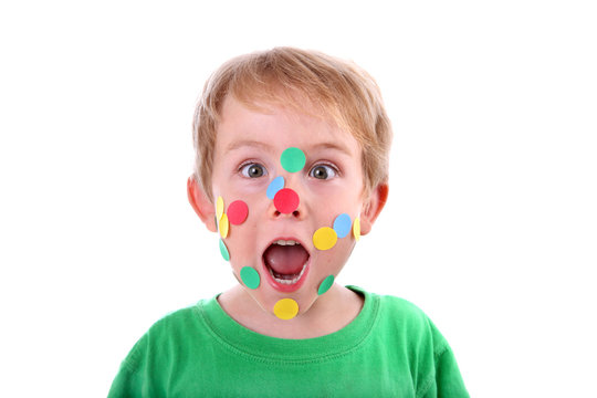 Boy with stickers on his face