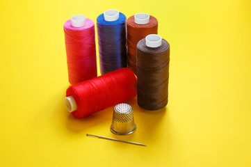 thread coils, thimble and a needle