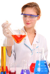 Girl chemist mixing liquids in test tubes