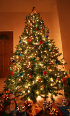 Fototapeta na wymiar A Shining Christmas Tree and Presents on Christmas Eve