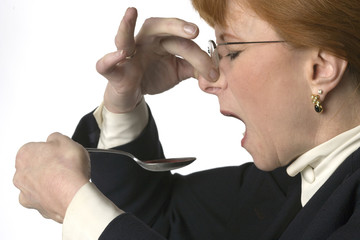 Woman taking nasty medicine
