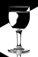 domino wine glasses in backlight on the black and white contrast