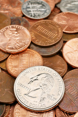 Quarter dollar over coin assortment macro closeup