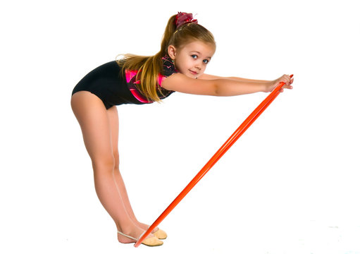 Little girl bending over a gymnastic ring