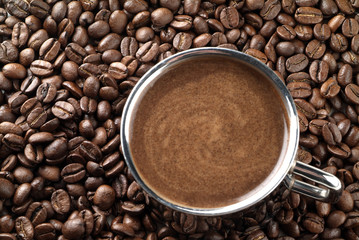 Fototapeta premium Cup with coffee, costing on coffee grain.