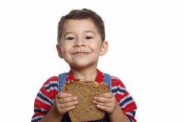 five-year-old boy with peanut butter and jelly sandwich