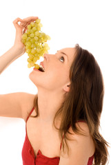 young woman eating grapes