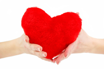 Close-up of red wooden heart in female hands
