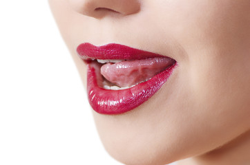 Beautiful woman leaking teeth with tongue close-up