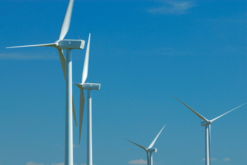 four windturbines on blue sky